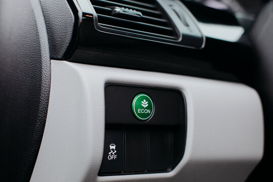 Econ mode button on dashboard in modern car.