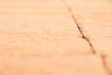Orange harsh texture brick wall with spot focus in a big close up detail 