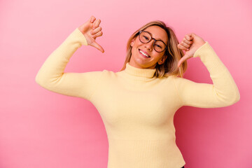 Young mixed race woman isolated on pink background feels proud and self confident, example to follow.