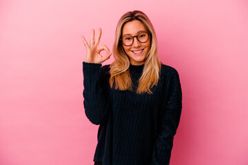 Young mixed race woman isolated on pink background cheerful and confident showing ok gesture.