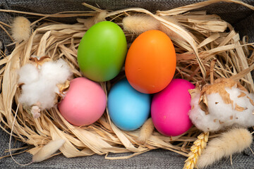 Easter Eggs in basket on yellow background