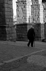 Old man with walking stick near the Segovia's aqueduct