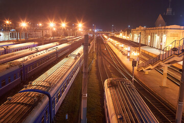 Fototapeta na wymiar Brest, Belarus - October 22, 2020 - Large railway transshipment point at night. Trains prepare to depart
