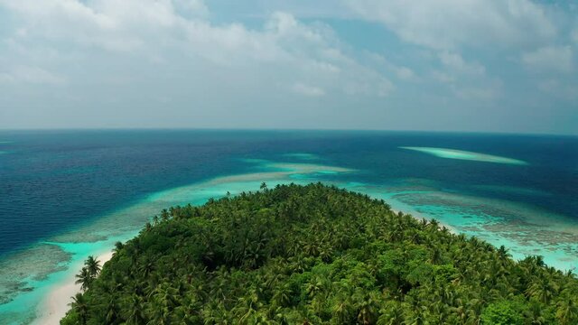 Aerial view of a tropical island in the Indian Ocean. Thinadhoo (Vaavu Atoll), Maldives