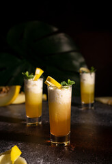 Photo for bar concept or magazines. Glasses of melon drink on dark background. Fresh and summer drink. laid out in layers with whipped cream