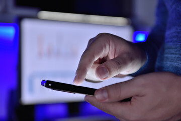 Businessman checks business report on smart phone.