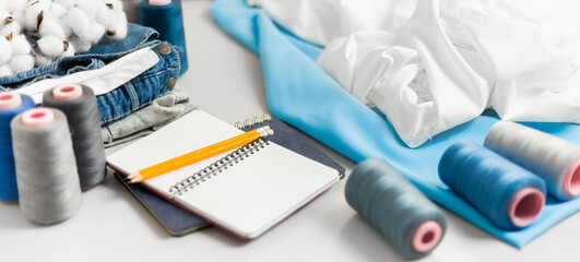 Individual tailoring. Handmade organic clothing. Sewing accessories on the table.