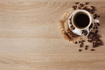 white cup of coffee, coffee beans, cinnamon, anise, background, view from above