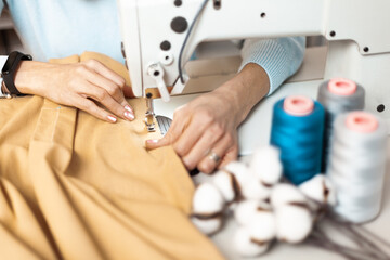 Workplace behind a sewing machine. Hand-sewn, organic sustainable fabrics. - obrazy, fototapety, plakaty