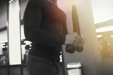 Handsome bodybuilder arms muscle workout at gym.