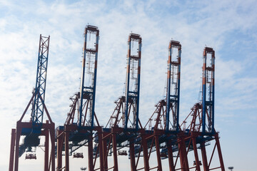 Fototapeta na wymiar Container terminal gantry cranes for loading and offloading intermodal containers from container cargo ships in Hamburg Germany