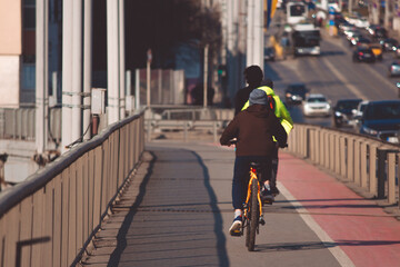 Young boy riding a bike on the sidewalk