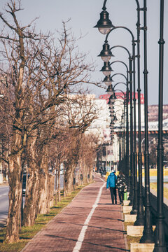 Children walking on a sidwalk with poles  in Iasi, Romania