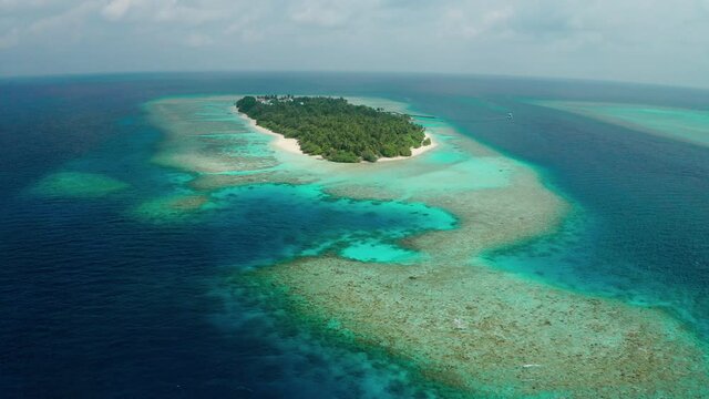 Aerial view of a tropical island in the Indian Ocean. Thinadhoo (Vaavu Atoll), Maldives