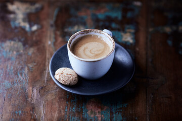 Cup of coffee on wooden background. Close up. 
