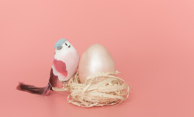 Easter eggs and a bird on a light pink background.