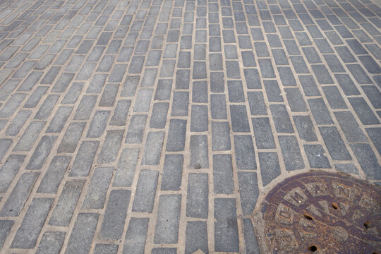 Urban City Street Brick Rock Road With Cast Iron Manhole Cover