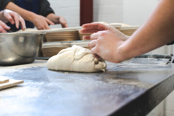 person kneading dough