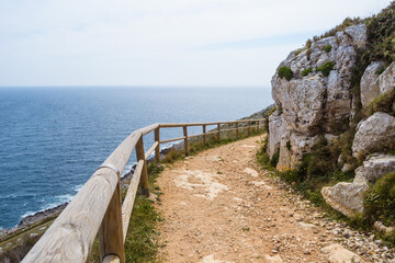 PATH THAT RUNS UP THE ROCKY WALL AND OVERLOOKS THE BLUE SEA
