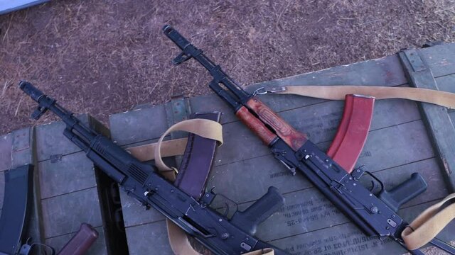 Kalashnikov assault rifles on military boxes.