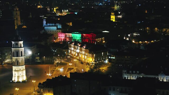 Vilnius old town at night of independence day. Aerial drone footage of cityscape in the dark. 