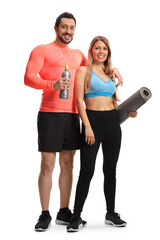 Full length portrait of a young sporty man and woman with an exercise mat