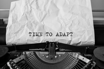 Text TIME TO ADAPT typed on retro typewriter