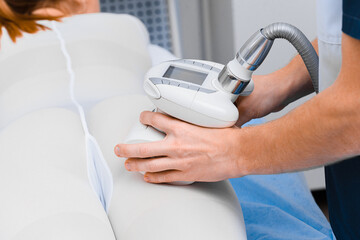 Vacuum roller anti-cellulite body massage close up.