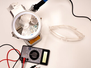 Picture of electronic repairing tools, consist of PCB holder stand, soldering iron, multimeter and...