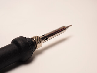 Close up shoot of soldering iron, a tool for soldering electrical components. Shoot on white...