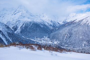 Fototapeta na wymiar Downhill skiing resort in high mountains, aerial view