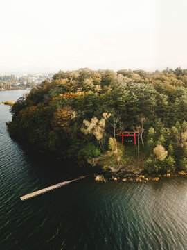 Aerial view of Uno island and the Tori entrance of the Shinto Temple in Kawaguchi Lake at sunset, Fujikawaguchiko, Minamitsuru, Yamanashi, Japan.