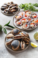 Seafood shellfish clams, mussels and scallops on gray plates