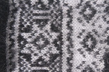 Winter or autumn ornament wool knitting black, white, grey texture background. Creative  carpet for christmas, wallpaper, wrapping, shop, card, textile