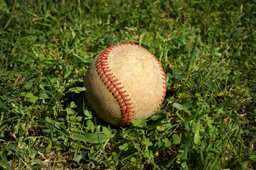 Old baseball on outfield grass