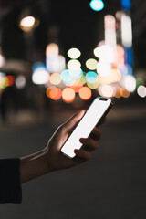 道の上でスマートフォンを開く人