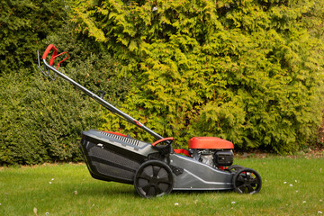 Lawn mower on the lawn, view from above. Lawn care in spring. New lawn mower. Copy space 