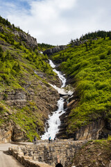 Fototapeta na wymiar Going-to-the-Sun Road with roadside waterfall, Glacier National Park, Montana