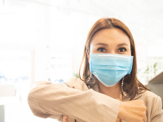 Company office manager supervisor businesswoman elbow pump african look at camera is wearing blue isolated empty mask for protection flu covid-19 corona virus disease danger super spread pandemic