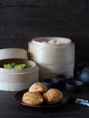 Fried Hedgehog Baozi. Assorted Chinese dim sum on dark background with copy space. Cute dim sum, animal bread.