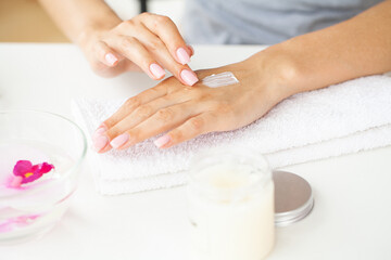 Obraz na płótnie Canvas Woman making manicure when resting at home