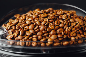 coffee beans in coffeemaker bean container, close-up view