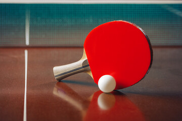 table tennis racket and ball, net background