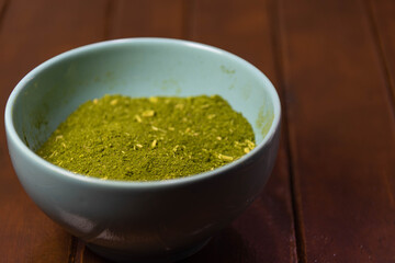 Mate herb (Ilex paraguariensis) ground in ceramic container for culinary and medicinal use
