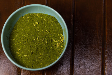 Mate herb (Ilex paraguariensis) ground in ceramic container for culinary and medicinal use