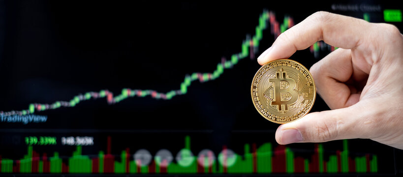 golden Bitcoin cryptocurrency coin with candle graph background, Crypto is Digital Money within the blockchain network, is exchanged using technology and online internet exchange. Financial concept