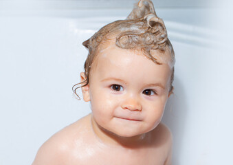 Child bathing. Little baby taking bath, closeup face portrait of smiling boy, health care and kids hygiene. Funny kids face close up.