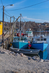 Fototapeta na wymiar Lobster Fishing Boats shored up at low tide on a village wharf
