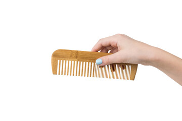 Female hand with stylish wooden comb isolated on white background.