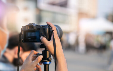 Man hands holding camara to record and live outdoor event
